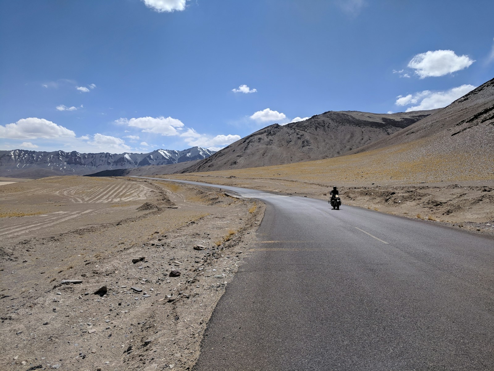 person riding motorcycle on road during daytime